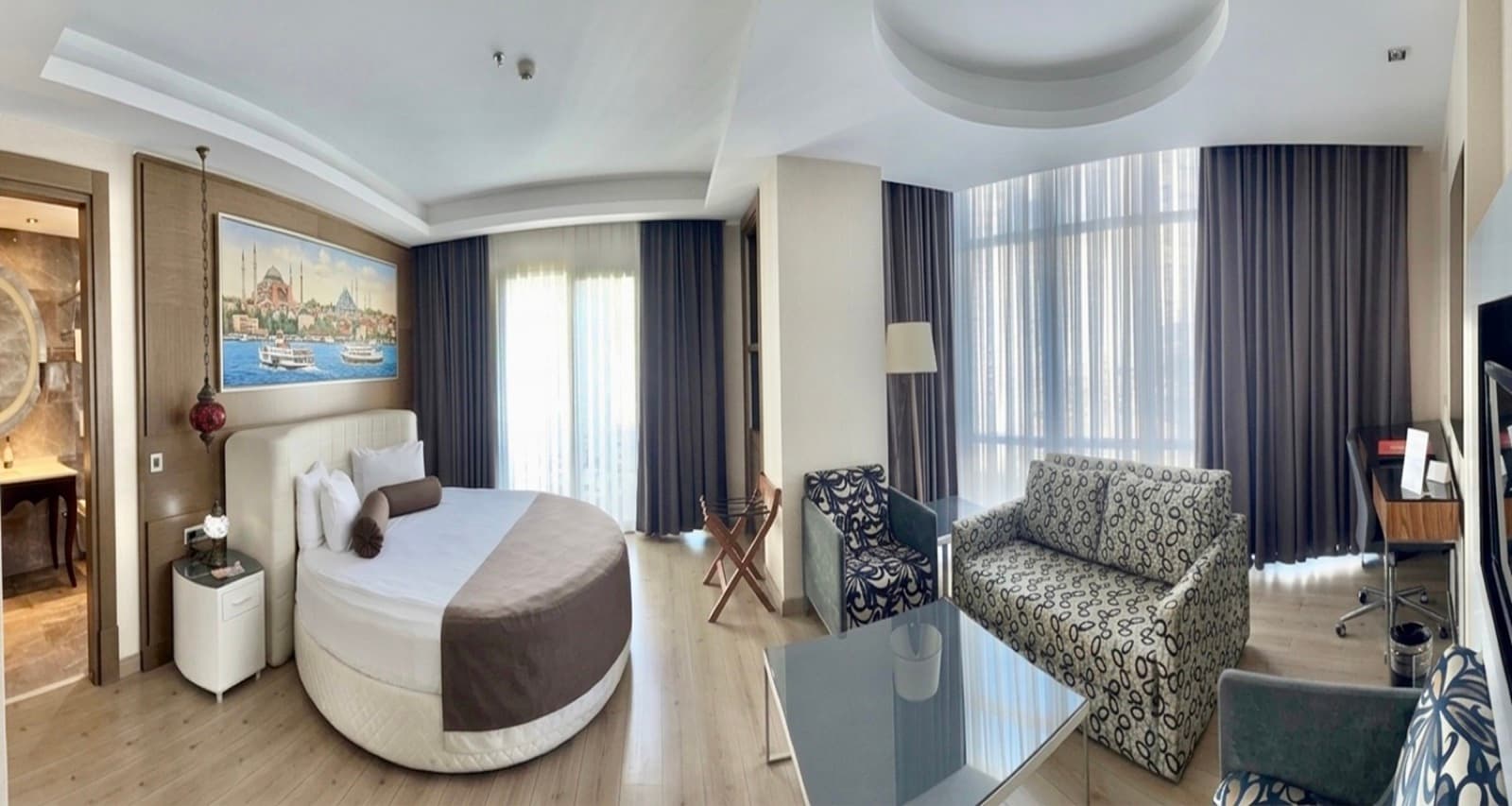 Suite at Hotel Dora Istanbul with a round bed, sitting area and floor-to-ceiling windows