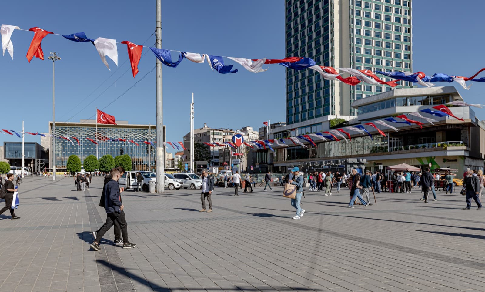 Open expanse of Taksim Square in Istanbul with flag bunting and the Ataturk Cultural Center
